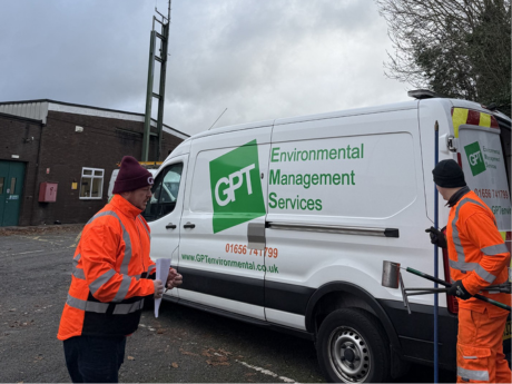 two gpt field engineers one holding sampling equipment the other holding paper with gpt van in background